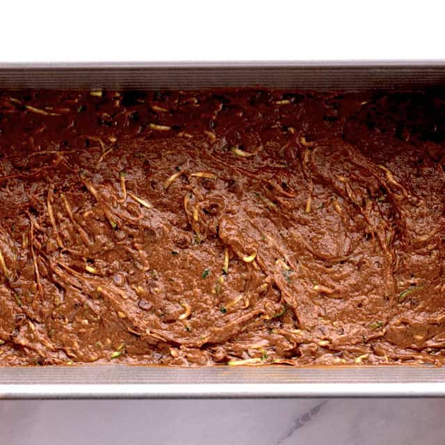moist zucchini bread batter in a loaf pan, ready to be baked.