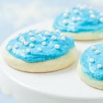 lofthouse sugar cookies topped with blue frosting and white sprinkles