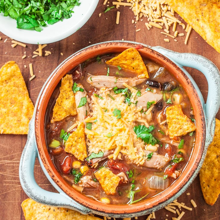 Mexican chicken soup in a bowl with nacho chips