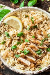 A bowl of Lemon Basil Orzo with Sliced Chicken and Basil