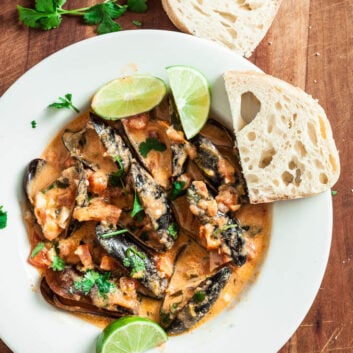 Red Thai Curry Mussels with Lime Wedges and Fresh Cilantro