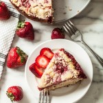 strawberry crumb caked, sliced with fresh berries on white plate