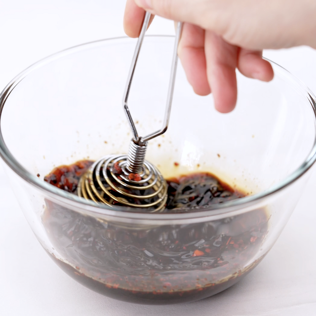 Thai basil chicken sauce being whisked together.