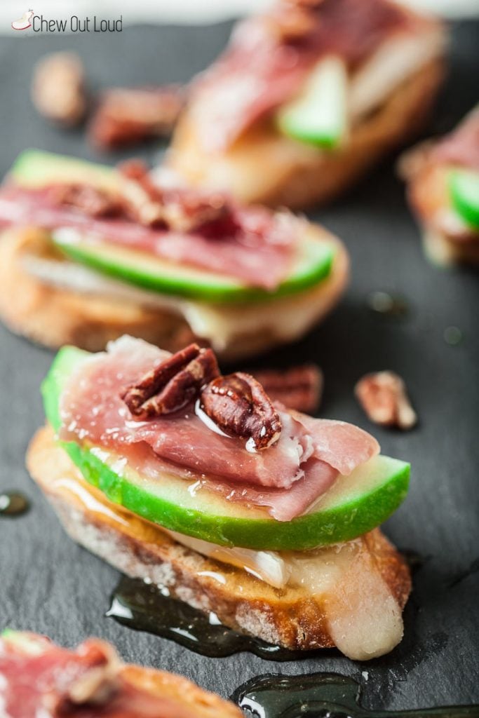 Prosciutto and apple slices and brie slices on crostini