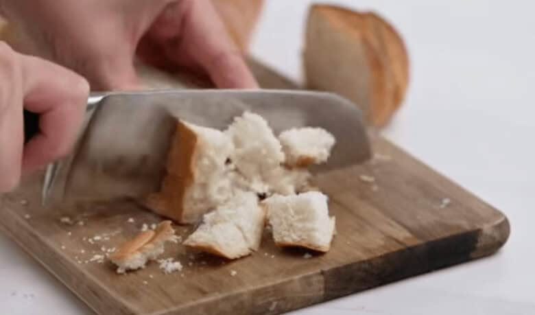 Dicing up the French bread for the French Toast Casserole.