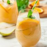 ginger pear sangria cocktail in glasses with mint sprigs
