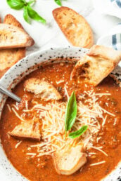 Tomato Basil Soup with Shredded Cheese and Crusty Bread