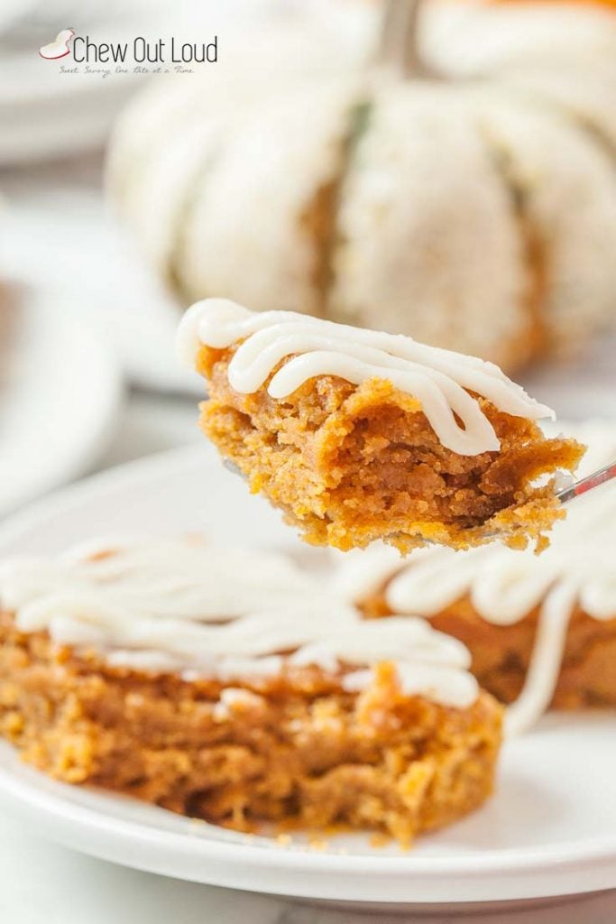 pumpkin bars with cream cheese icing cut on a plate