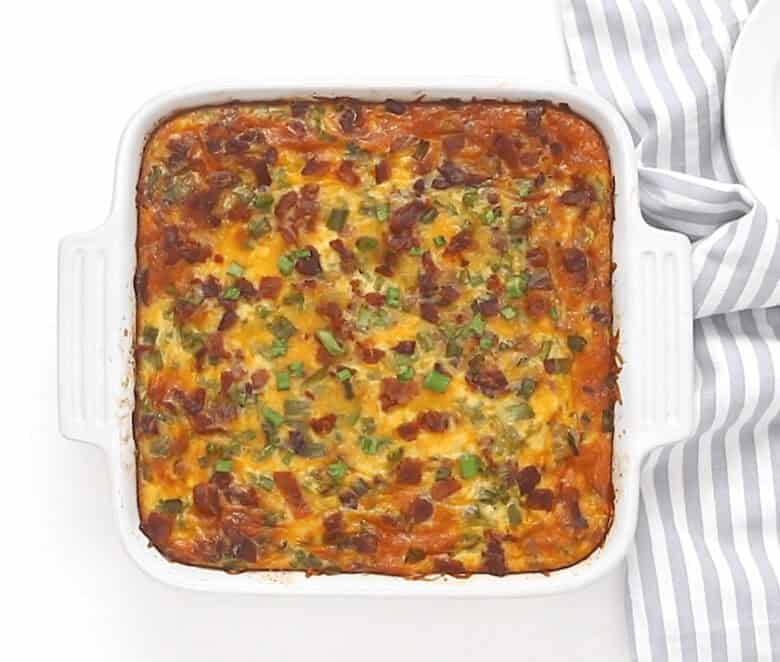 Removing the baked casserole from the oven and letting it cool.