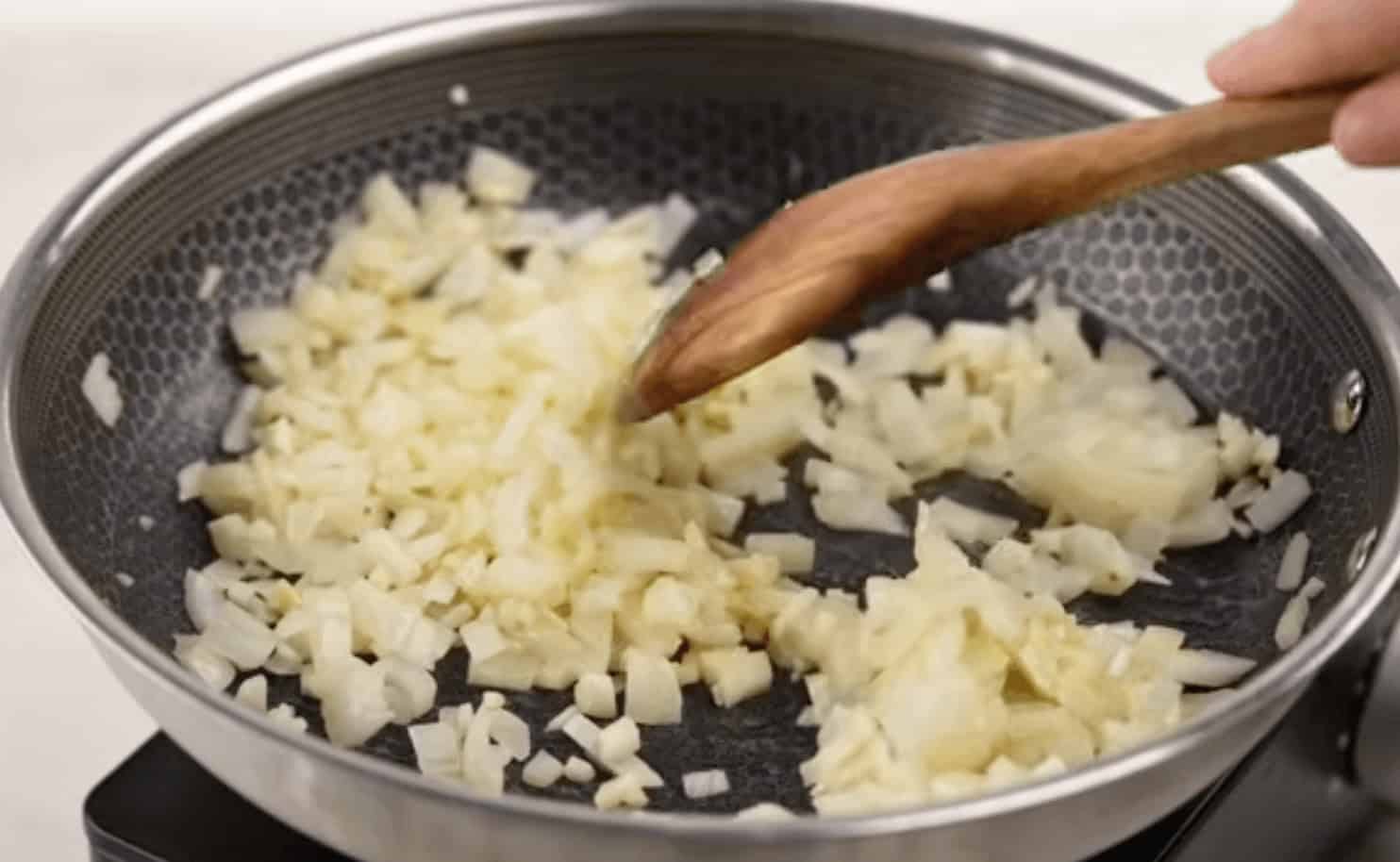 Cooking the onions and garlic in a saucepan.