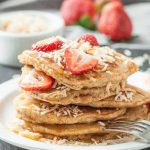 coconut pancakes with strawberries and shredded coconut