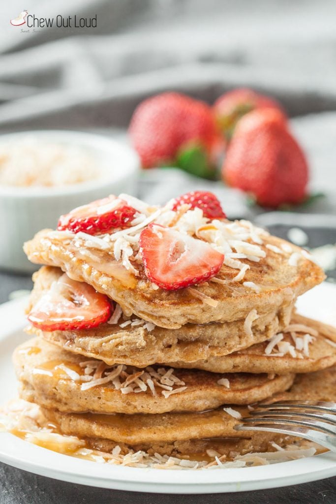 fluffy coconut pancakes with strawberries and toasted coconut