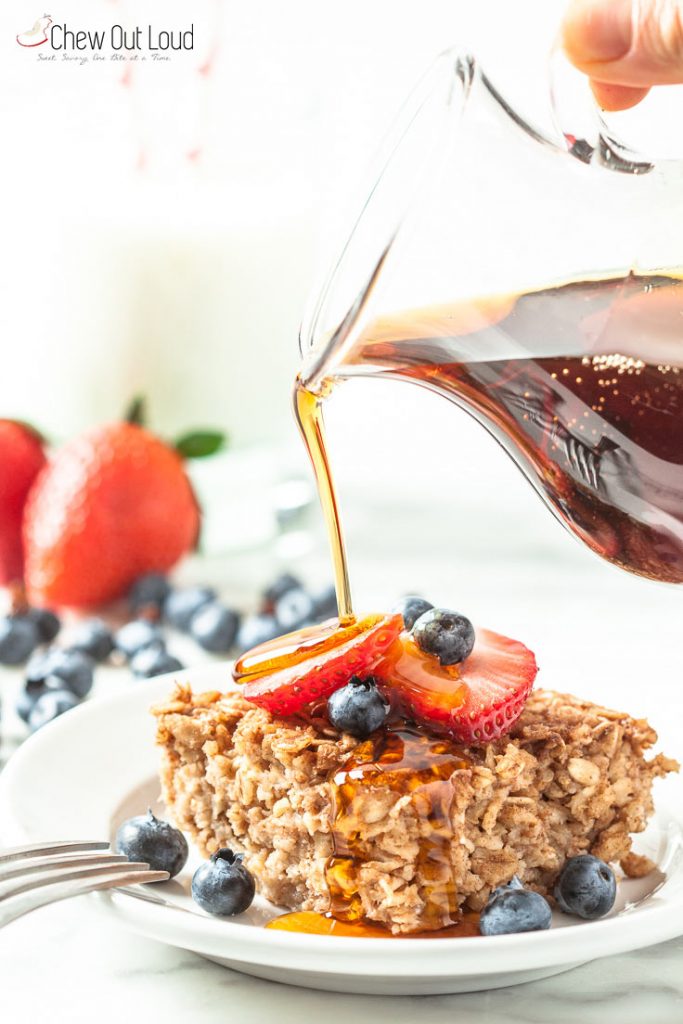 Pouring of Syrup on Baked of Maple Cinnamon Oatmeal with Strawberry & Blueberry on Top