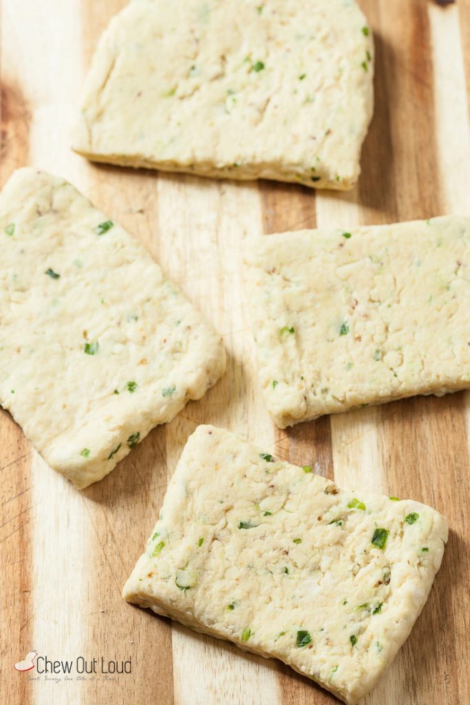 A flat dough of cheddar and chives scones