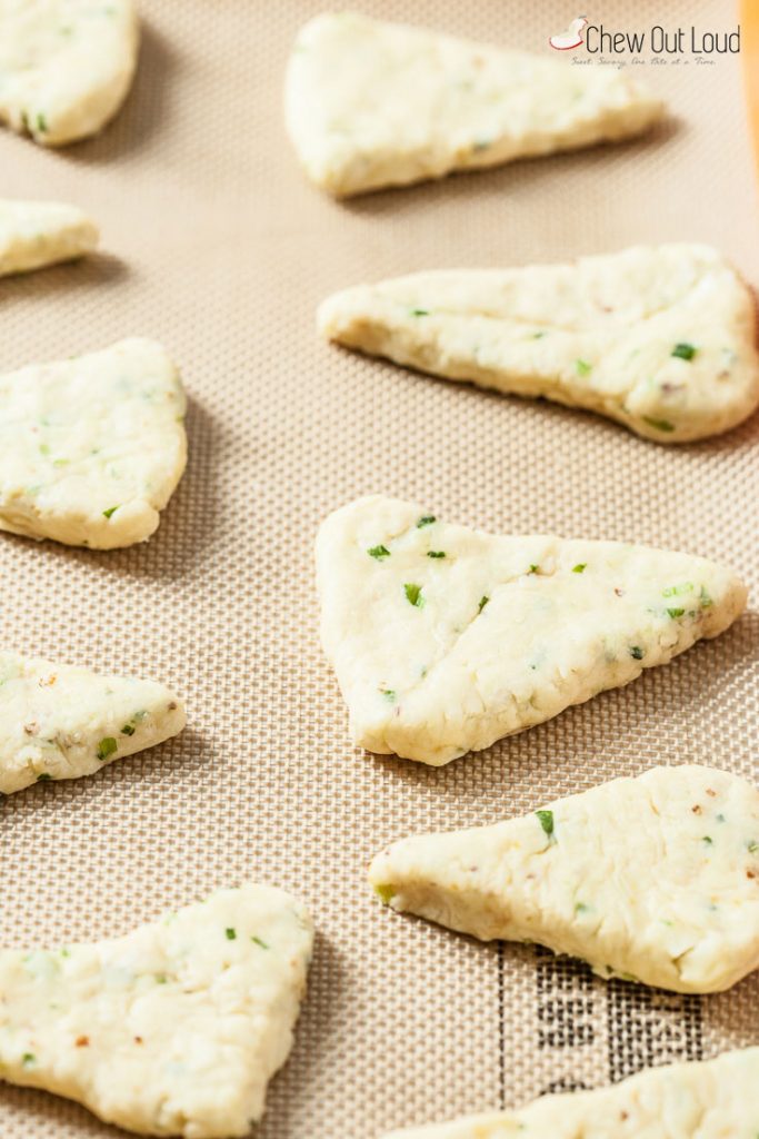 A shaped of dough of cheddar and chives scones