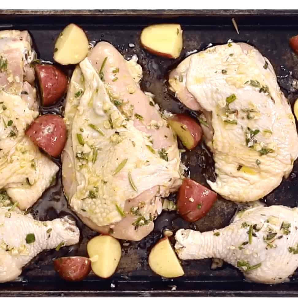 Place the coated chicken and potatoes onto a baking sheet to roast.