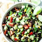 avocado salsa with black beans and tomatoes in a bowl