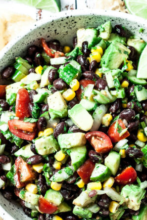 avocado salsa with black beans and tomatoes in a bowl