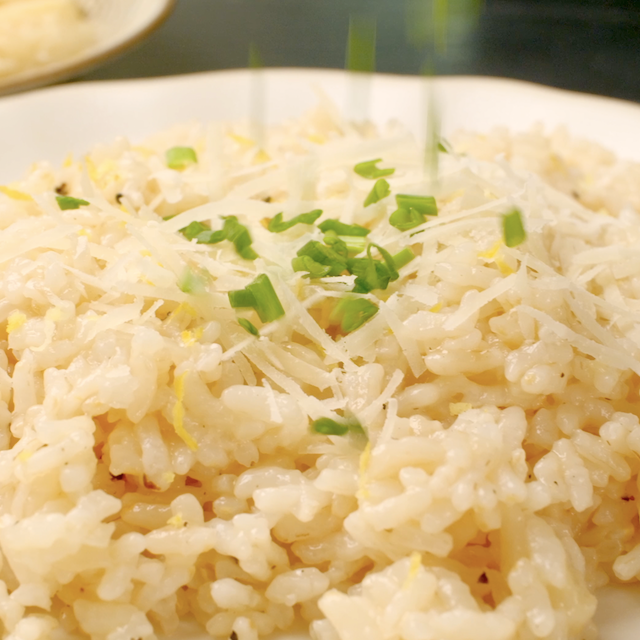Chopped chives being garnished on top of freshly made instant pot risotto.