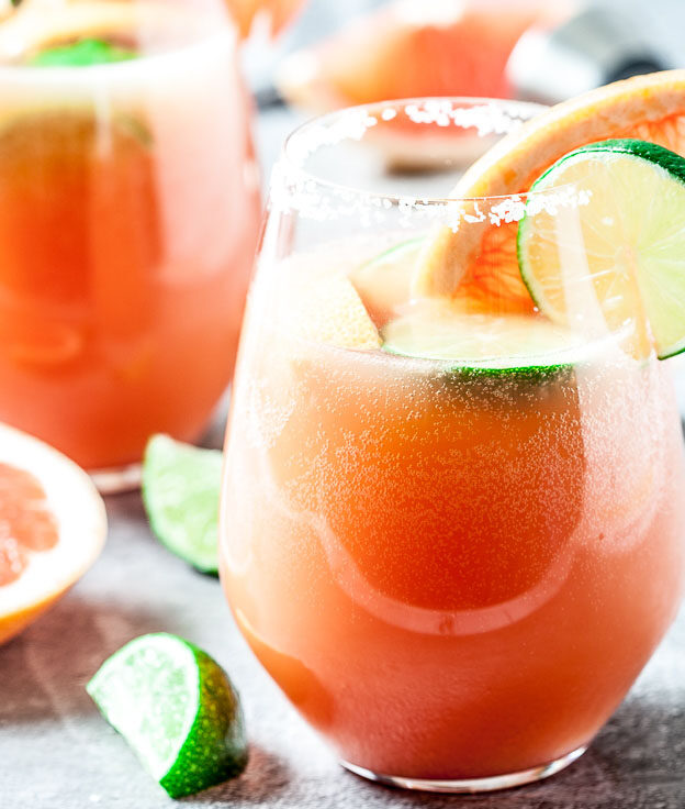 grapefruit paloma cocktail with lime slices in glasses