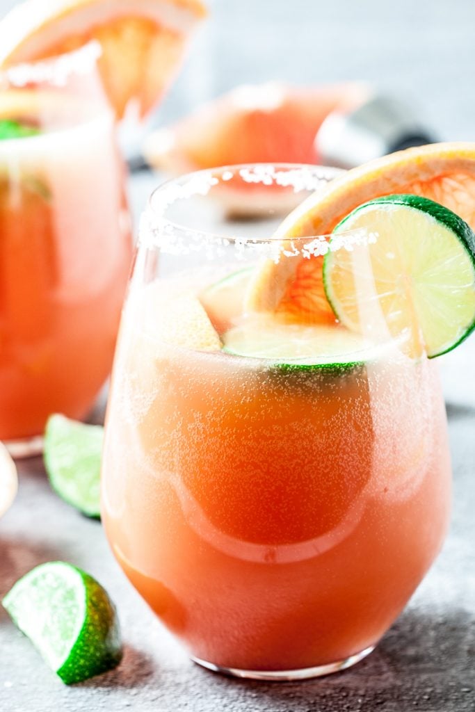 grapefruit paloma cocktail in glasses with lime slices