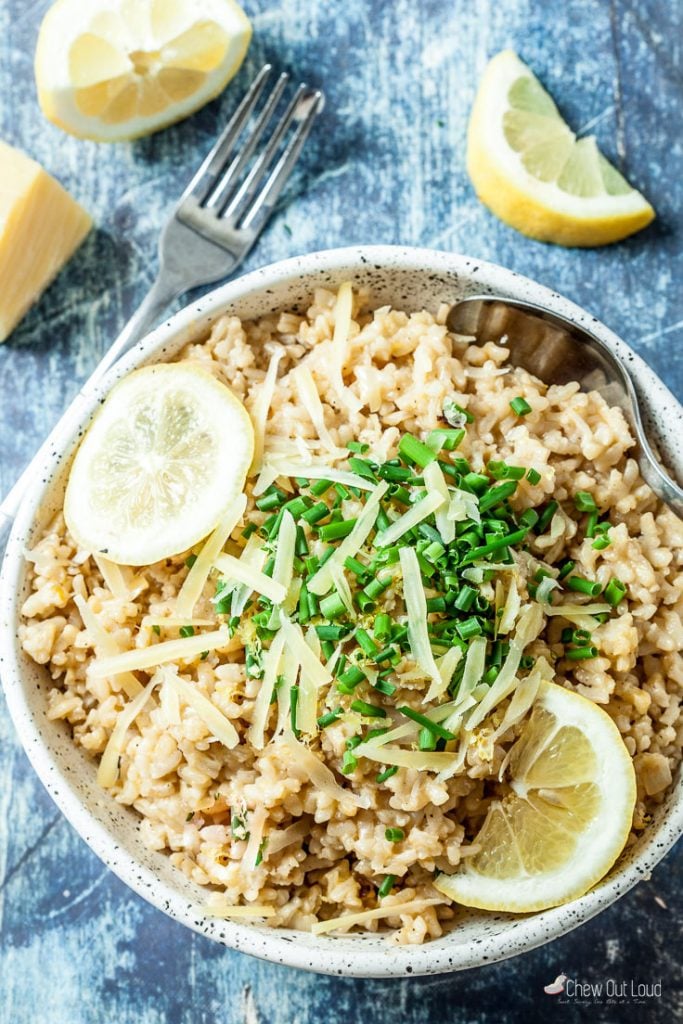 Bowl of Risotto with Chopped Chives and Sliced Lemon