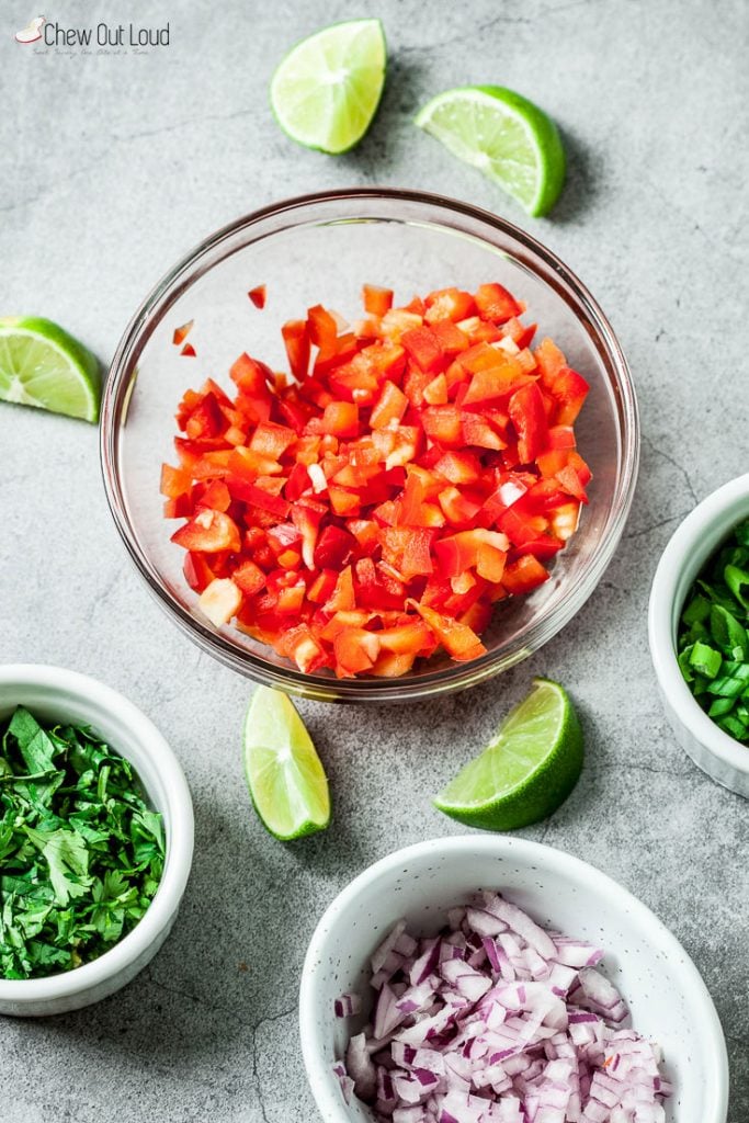 diced tomatoes, onions, and cilantro in bowls