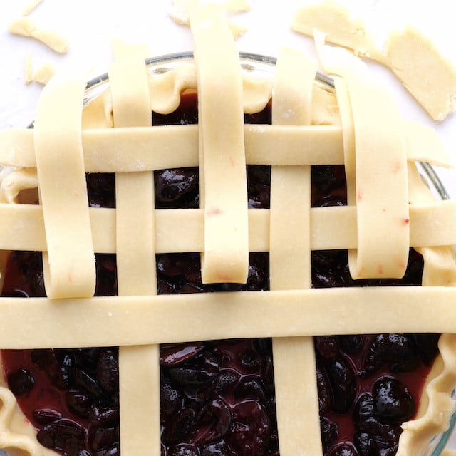 Lattice pattern being made to make sweet cherry pie at home.