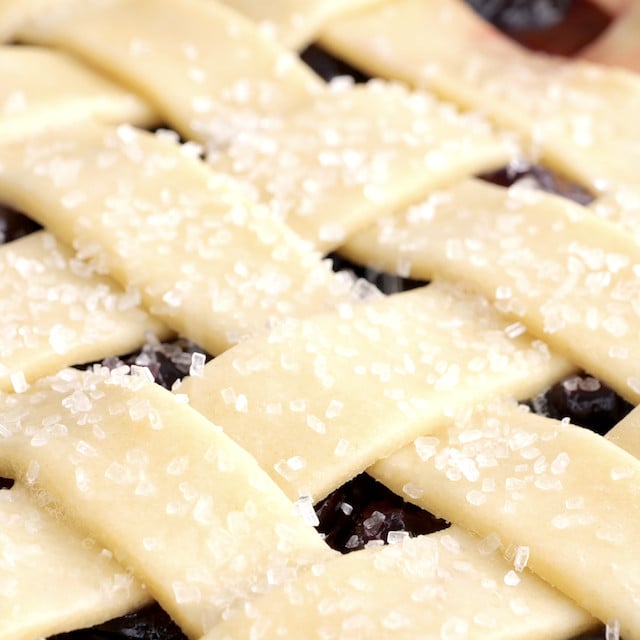 Coarse sugar sprinkled on top of sweet cherry pie crust before baking.