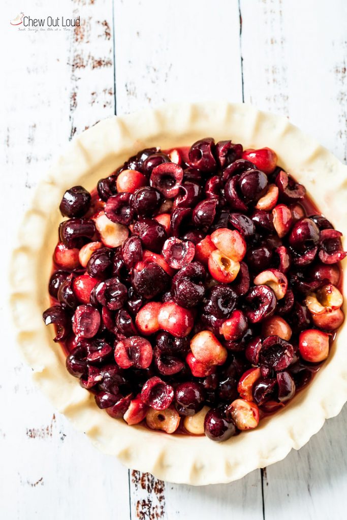 fresh pitted cherries in a fresh pie crust in pie pan