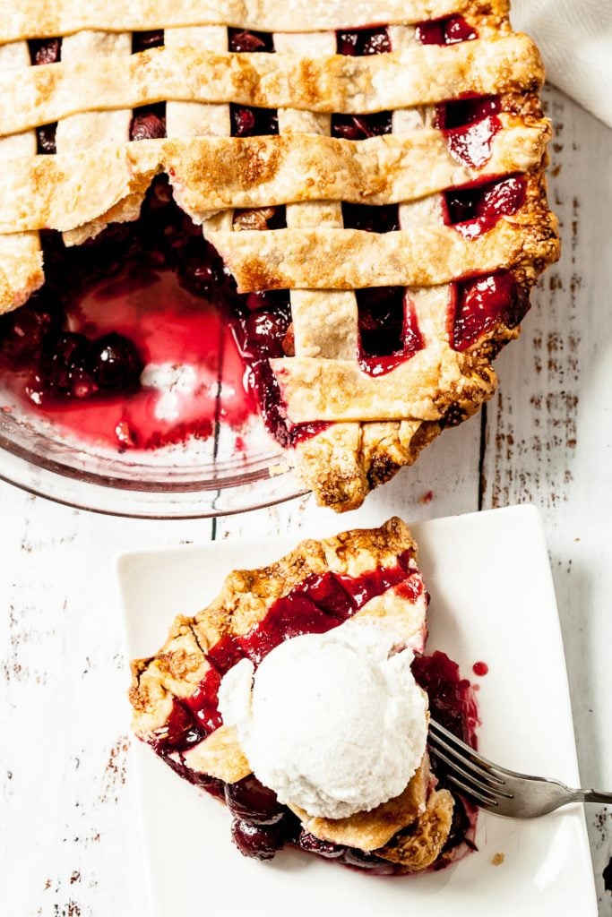 Homemade cherry pie with lattice top crust and ice cream