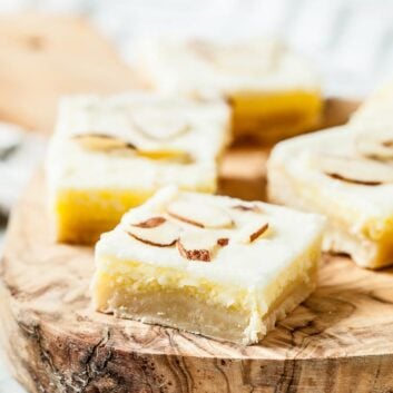 almond dessert bars with slivered almonds on top, cut into squares