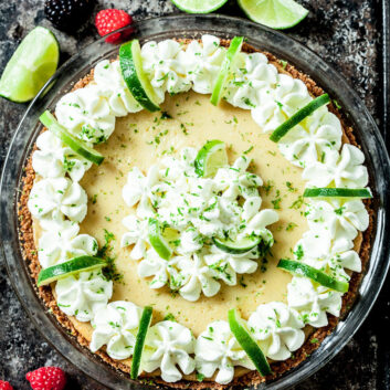 key lime pie with whipped cream and lime slices