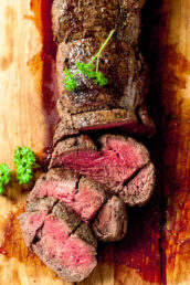 beef tenderloin sliced on a cutting board