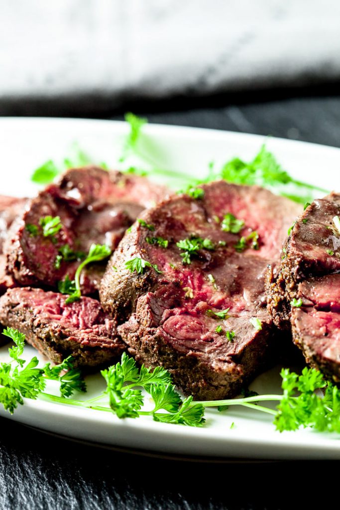 beef tenderloin roast on white plate