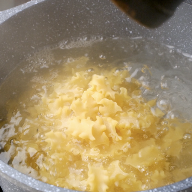 Pasta being boiled in a pot to make easy lasagna soup.