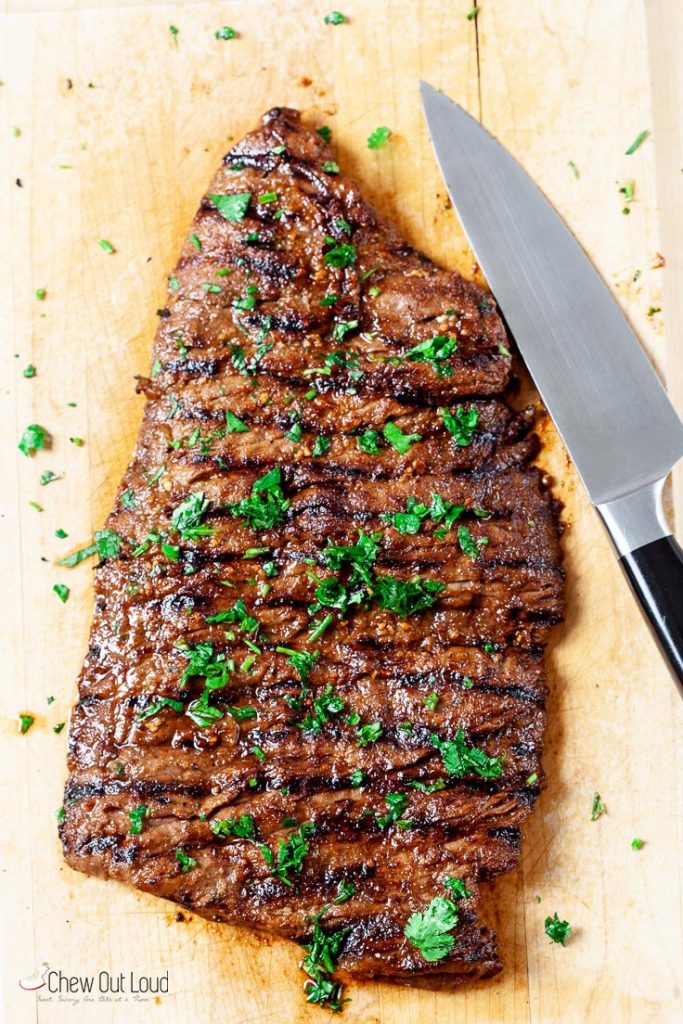 Grilled carne asada on cutting board