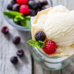 vanilla ice cream in a bowl with fresh berries