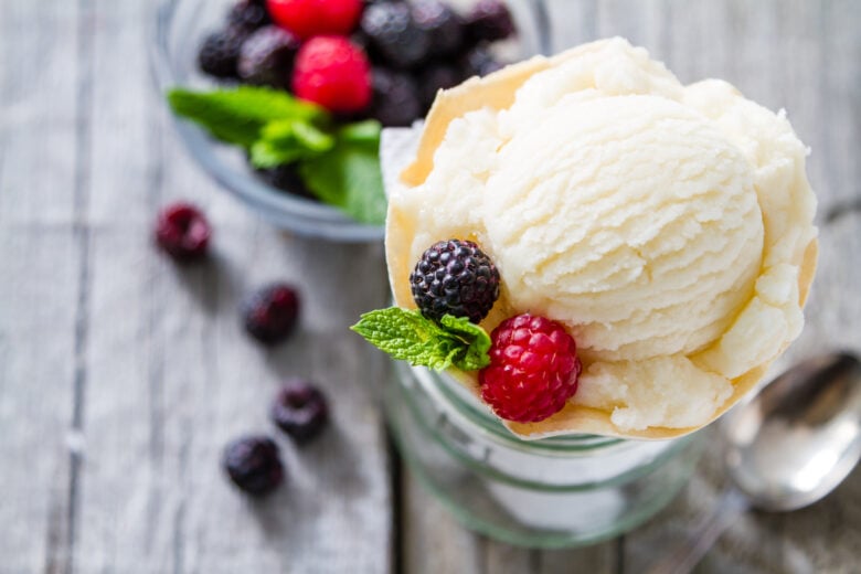 vanilla ice cream in a bowl with fresh berries