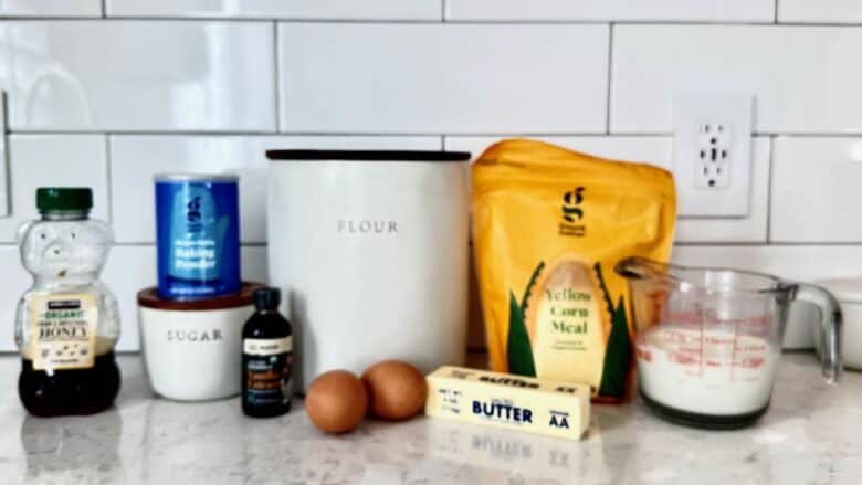 Sweet honey cornbread ingredients including butter and cornmeal.