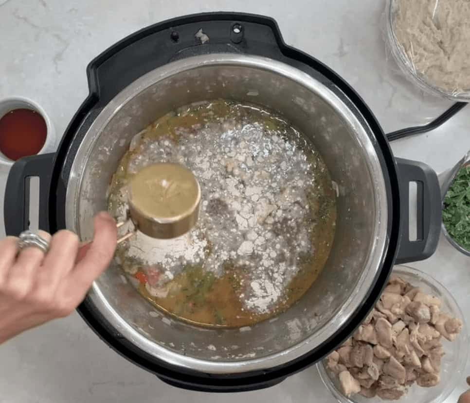 Adding the seasonings into the Instant Pot for the Chicken and Dumplings recipe.