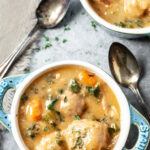 instant pot chicken and dumplings in two little bowls with spoons
