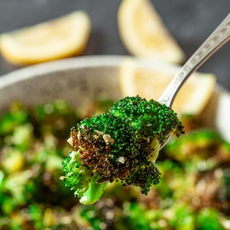 Air Fryer Broccoli floret on a fork. 