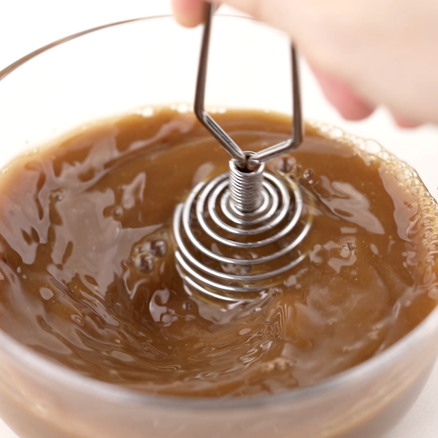 Beef and broccoli stir fry sauce being whisked.