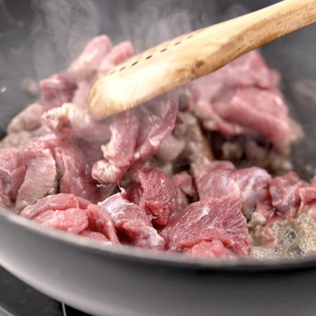 Beef being seared to make beef and broccoli stir fry.