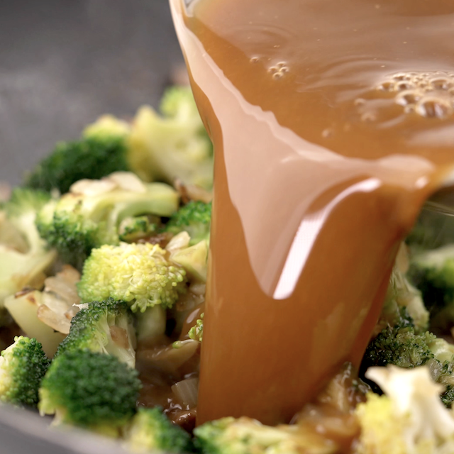 Sauce being added to make beef and broccoli stir fry.