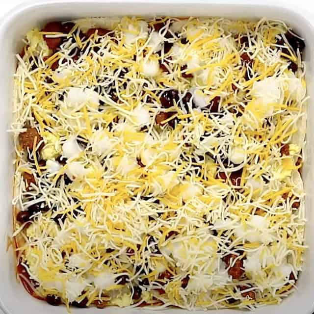Cheese layered on top to make Mexican breakfast casserole.