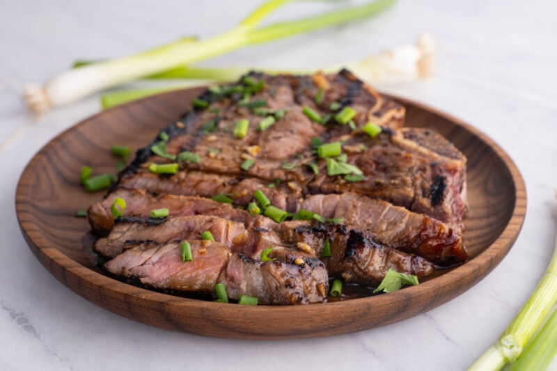 marinated ribeye steaks sliced on a plate