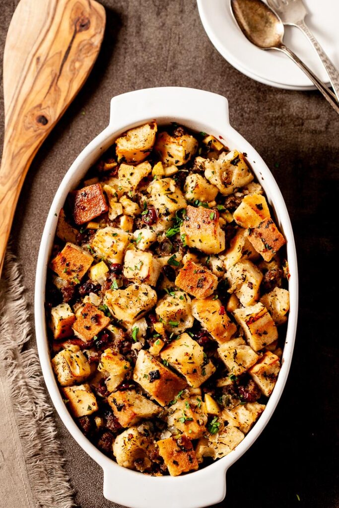 Homemade Stuffing with Sausage and Apples in White Dish