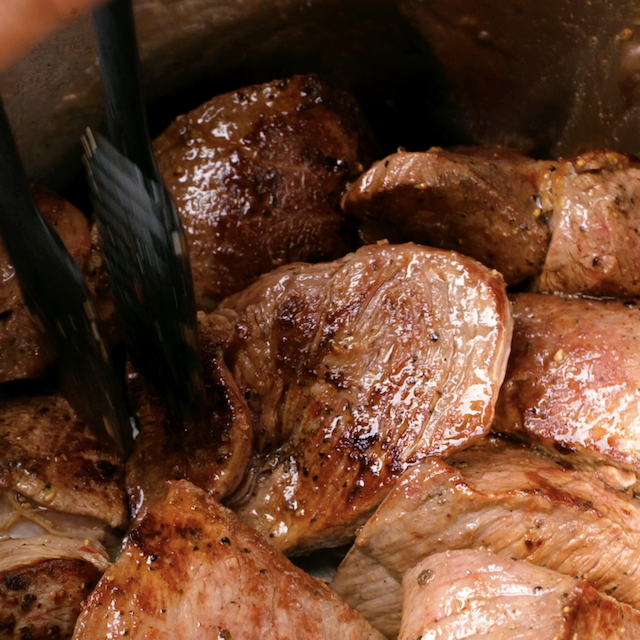 Beef pieces being browned on all sides to make instant pot roast beef.